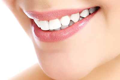 An image of a person with a bright smile, showcasing their teeth and lips.