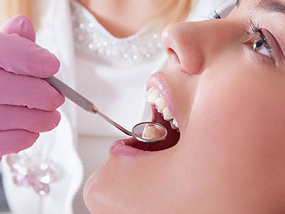 A dental professional performing oral care on a patient.